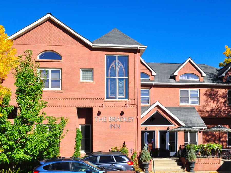 A brick building with a sign reading "The Bradley Inn."
