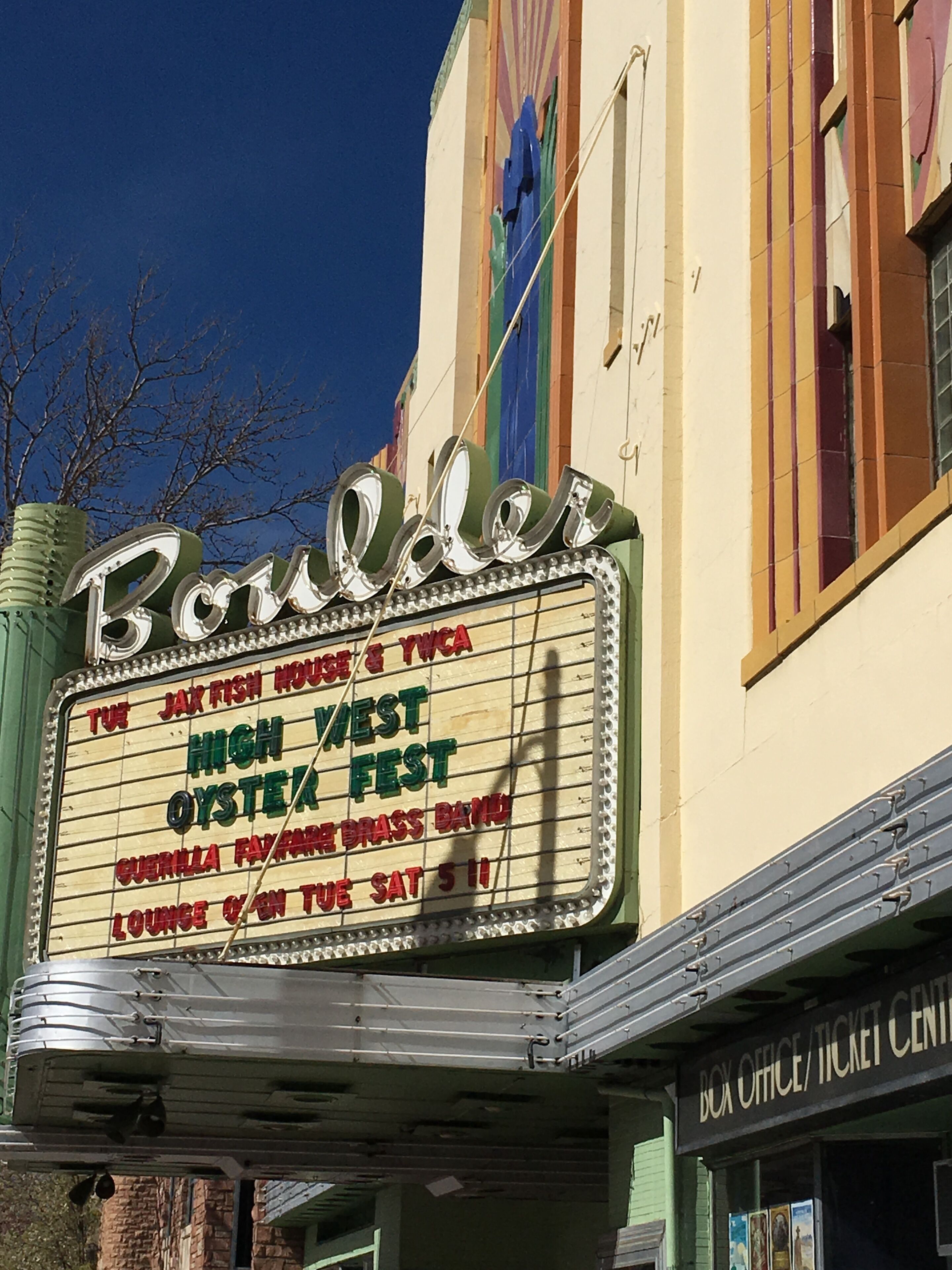 A theater marquee with the name "Boulder" and event listings.