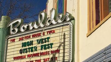 A theater marquee with the name "Boulder" and event listings.