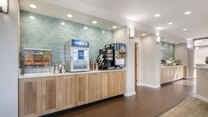 A modern kitchen with a built-in refrigerator, coffee machine, and a pull-out pantry. - Surf and Sand, BW Signature Collection (Fernandina Beach)