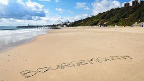 A beach with the word "Bournemouth" written in the sand. - Marsham Court Hotel (Bournemouth)
