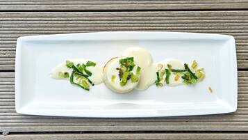 A white rectangular plate with a food arrangement on a wooden surface.