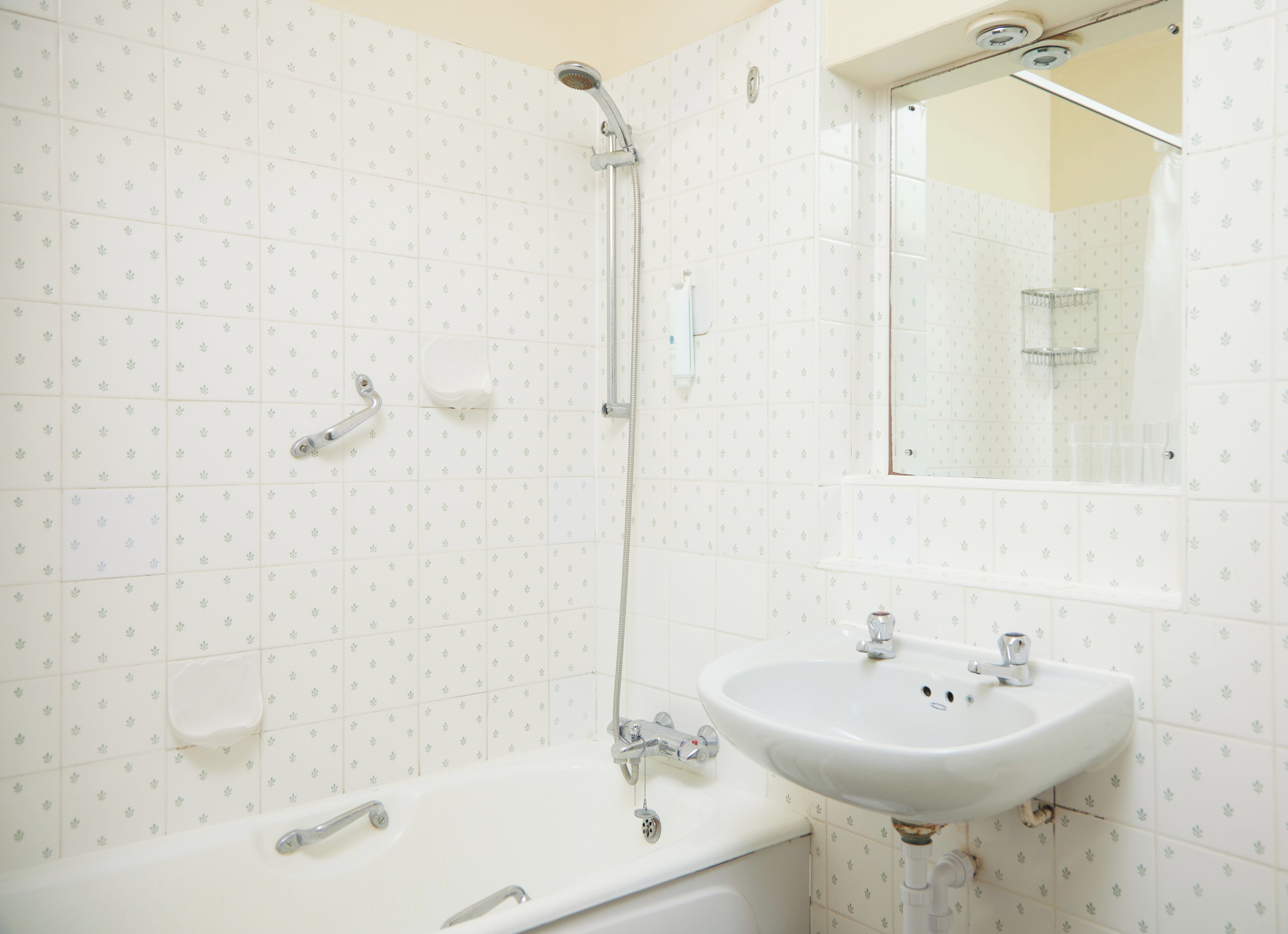 A bathroom with a bathtub, a sink, and a shower.