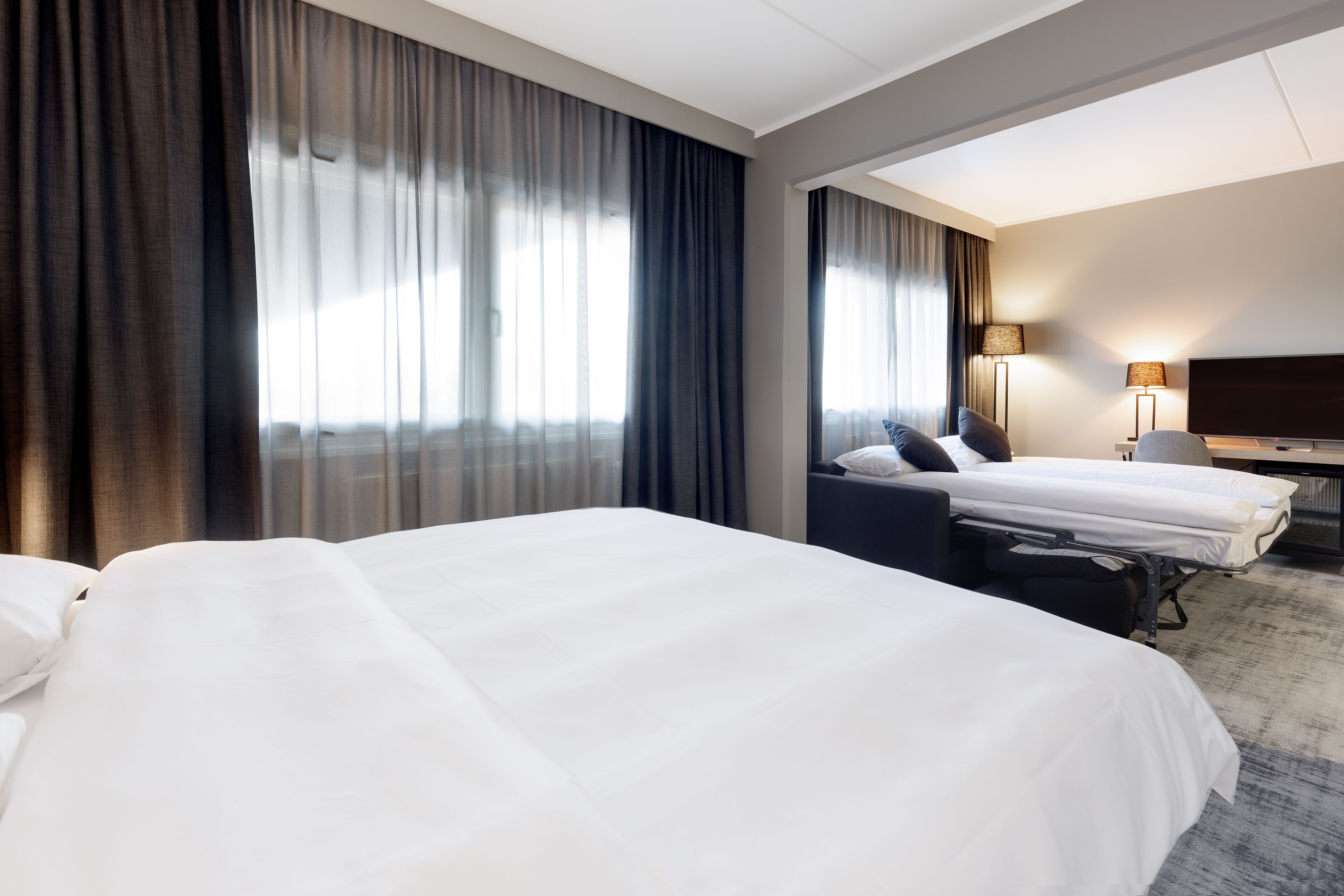 deluxe room (family) | in-room safe, desk, blackout curtains, soundproofing