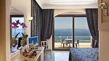 Habitación doble Deluxe, vista al mar | Minibar, caja de seguridad en la habitación y escritorio