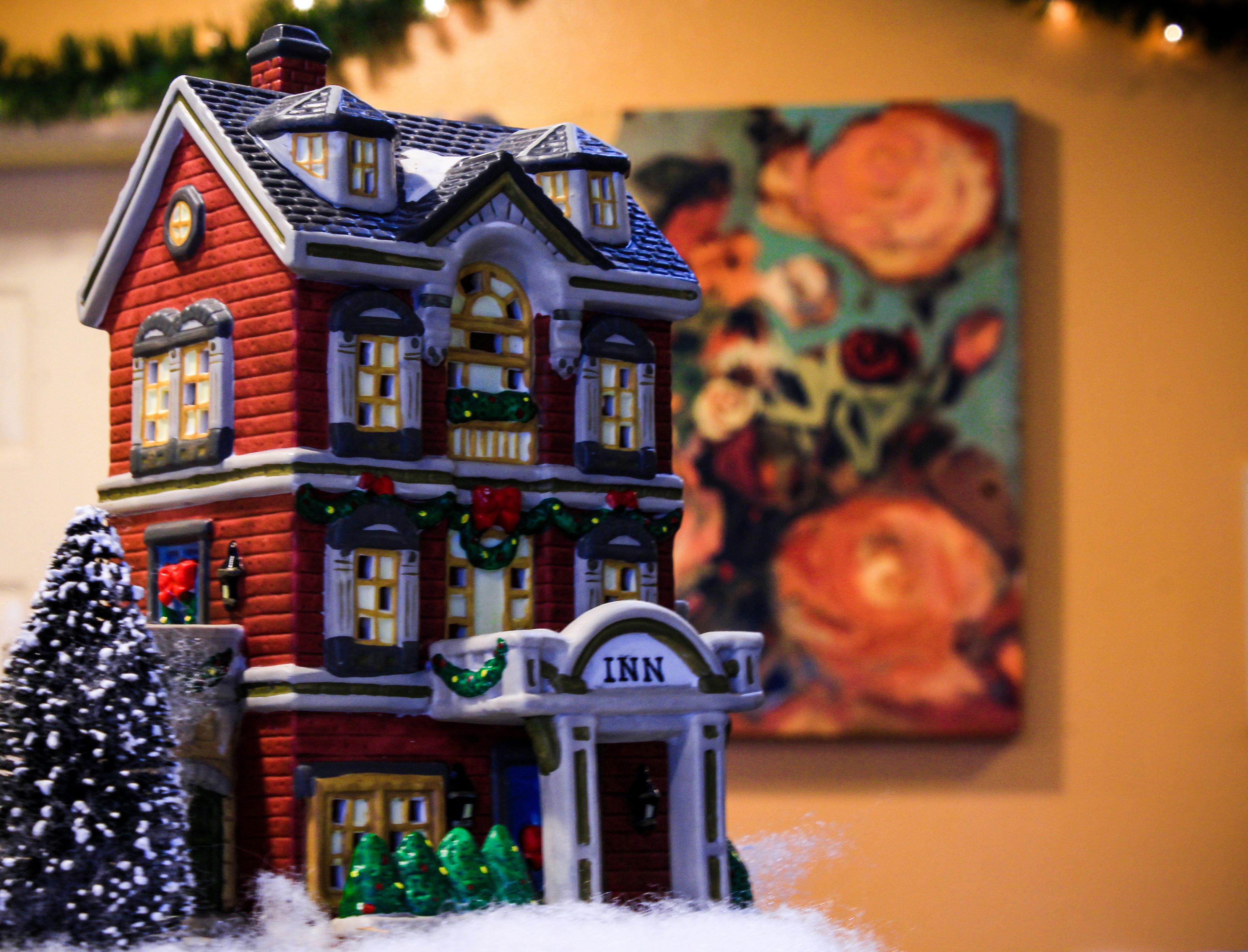 A model of a red brick building with a sign reading "Inn" on the front.