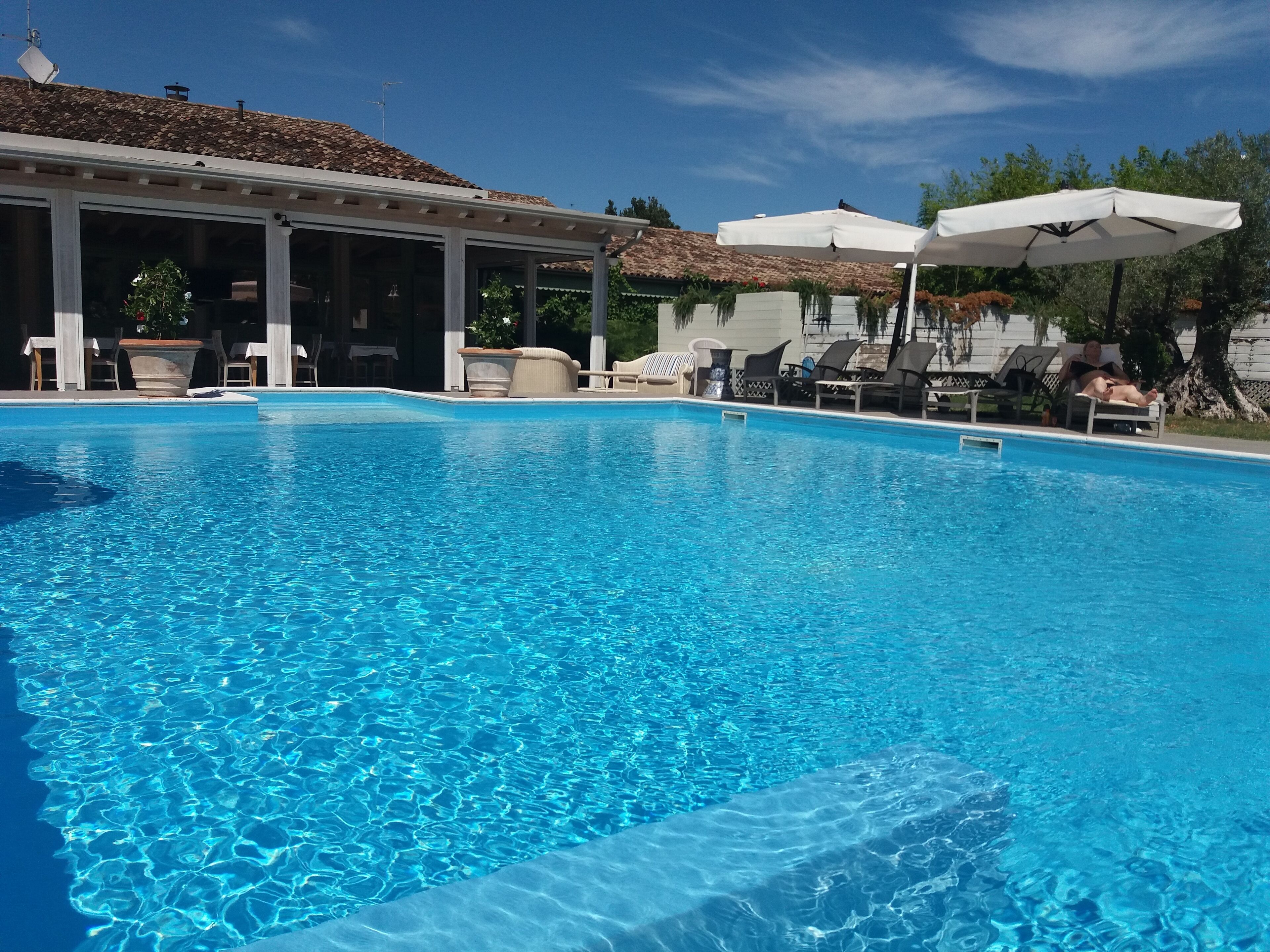 Seasonal outdoor pool, a rooftop pool, pool umbrellas, pool loungers