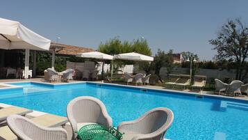 Seasonal outdoor pool, a rooftop pool, pool umbrellas, pool loungers