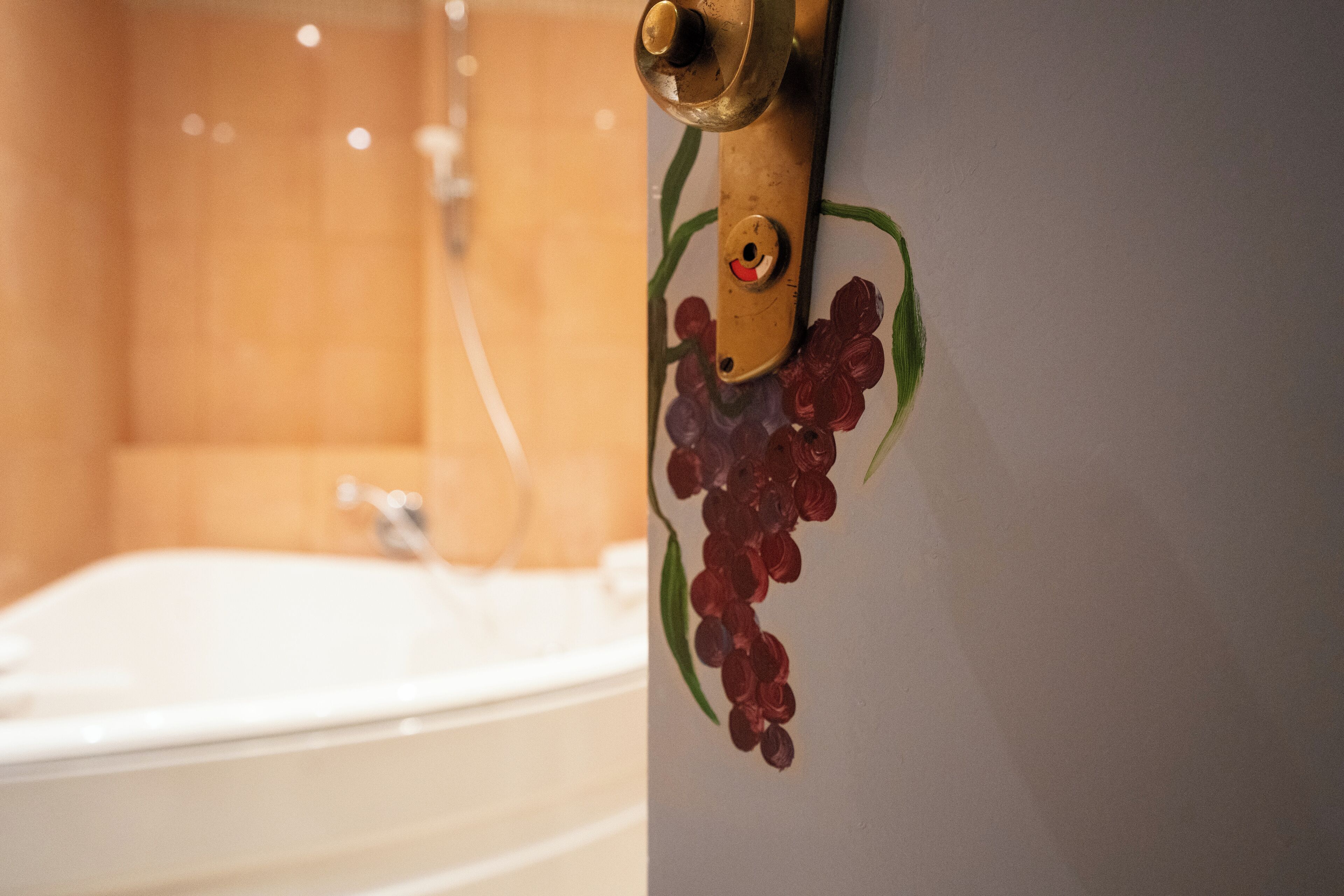 A bathroom with a bathtub, a shower, and a wall-mounted faucet.
