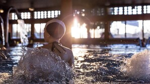 A person in a swimming pool with sunlight streaming through windows. - Hotel Terme Salvarola (Sassuolo)
