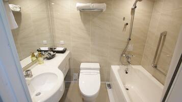 A modern bathroom with a sink, toilet, and bathtub.
