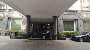 A hotel entrance with a covered entrance, columns, and a BMW parked nearby. - Park Inn by Radisson New Delhi Lajpat Nagar (New Delhi)