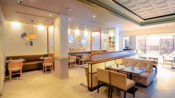 A restaurant with booths, tables, and chairs.