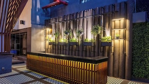 A modern reception area with a wooden counter, vertical light panels, and potted plants. - Park Inn by Radisson New Delhi Lajpat Nagar (New Delhi)