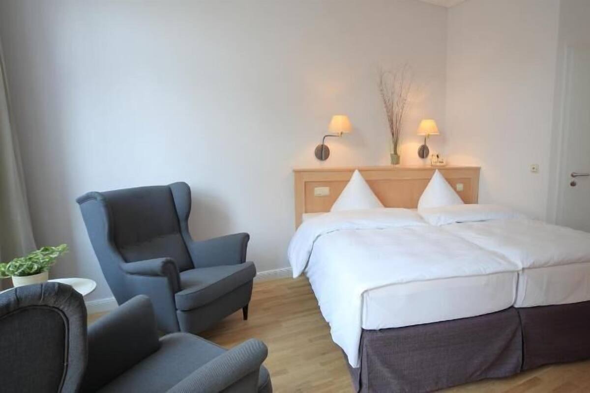 Ropa de cama hipoalergénica y caja de seguridad en la habitación