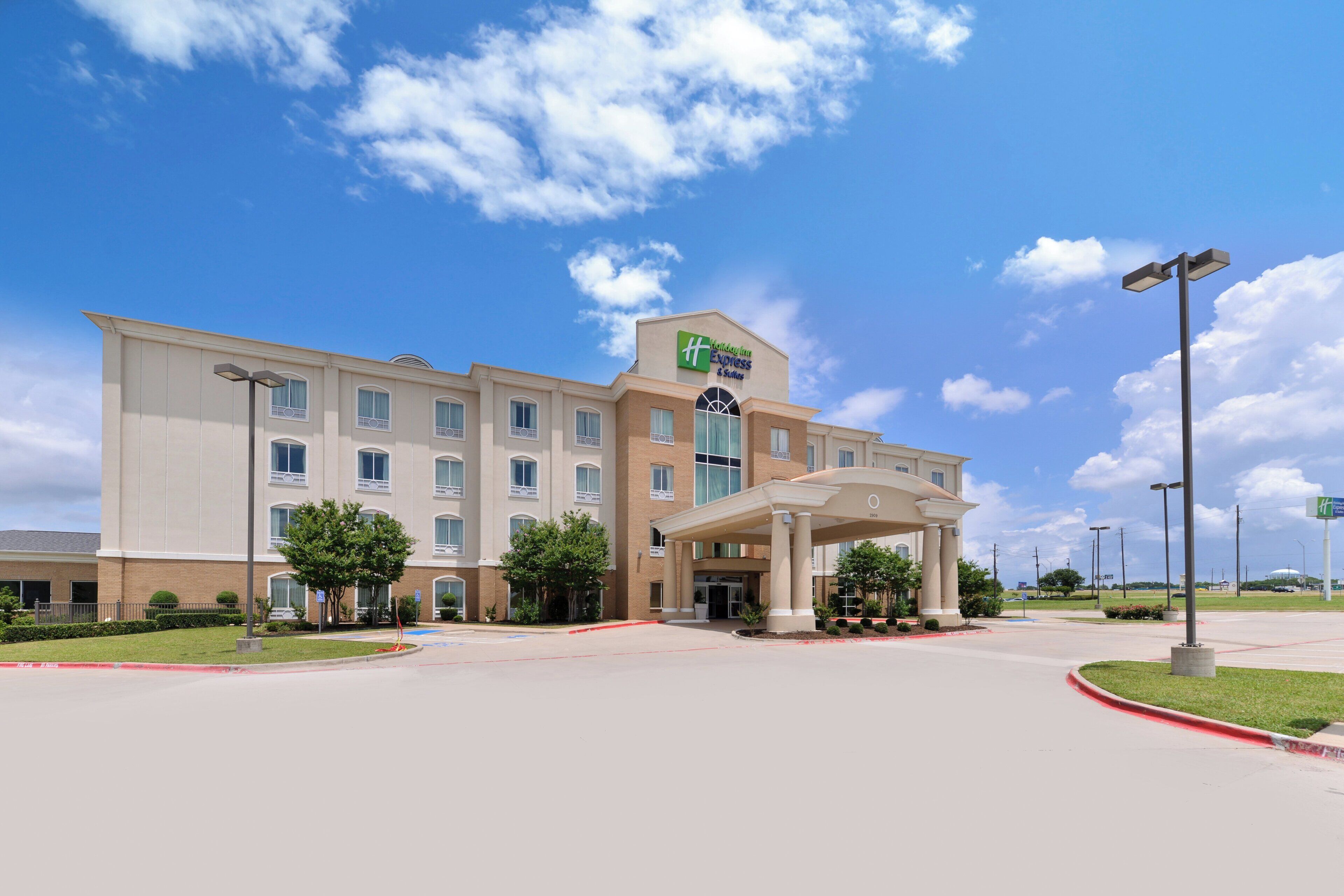 A large, multi-story hotel with a prominent entrance and a covered area.