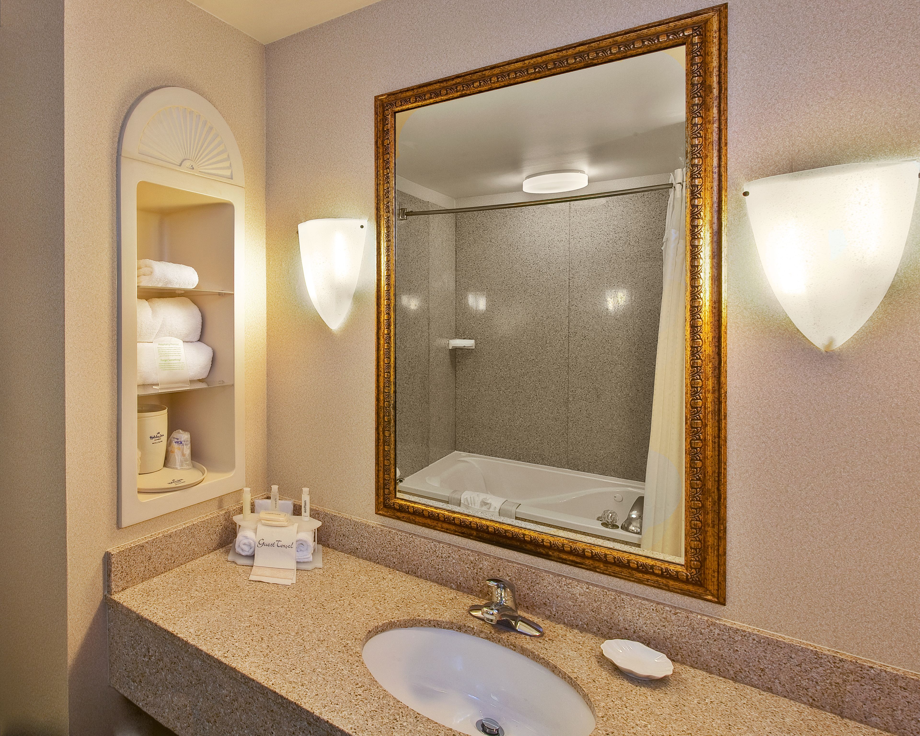 suite, 1 king bed, jetted tub (whirlpool) | bathroom | combined shower/bathtub, hair dryer, towels