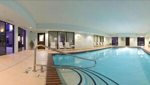 An indoor swimming pool with a clear waterline, a pool ladder, and lounge chairs along the side. - Holiday Inn Express Hotel & Suites Dyersburg by IHG (Dyersburg)