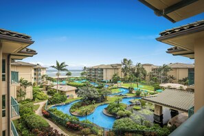 A resort with a pool area, palm trees, and a view of the ocean. - Waipouli Beach Resorts & Spa Kauai by OUTRIGGER (Kapaa)