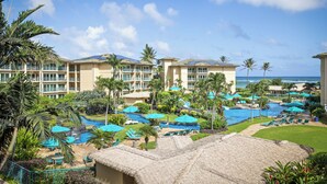 Un resort con varias edificaciones, una piscina y vista al océano.