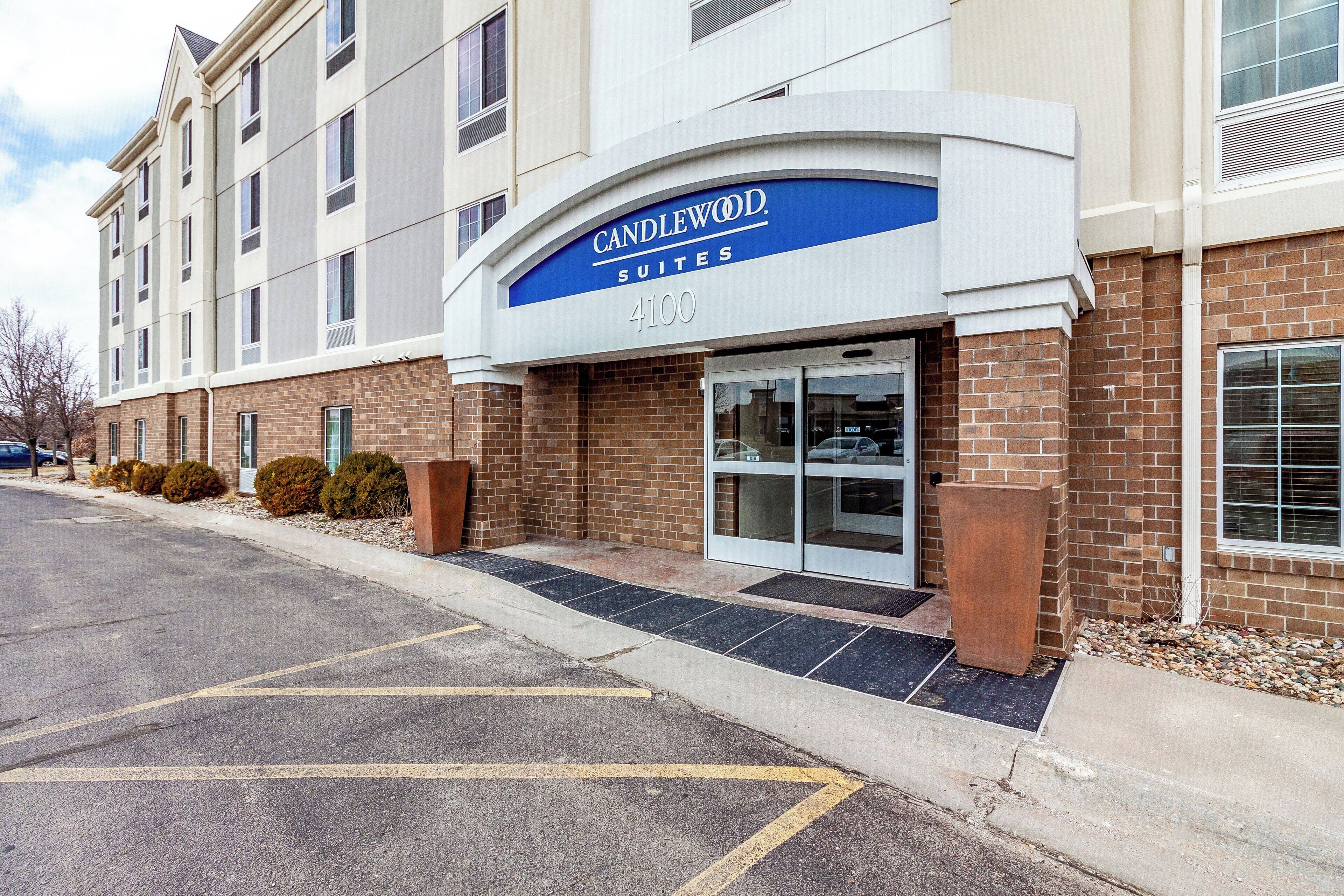A building with a sign reading 'Candlewood Suites 4100' indicating a hotel or motel.