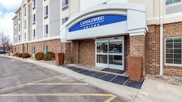 A building with a sign reading 'Candlewood Suites 4100' indicating a hotel or motel.