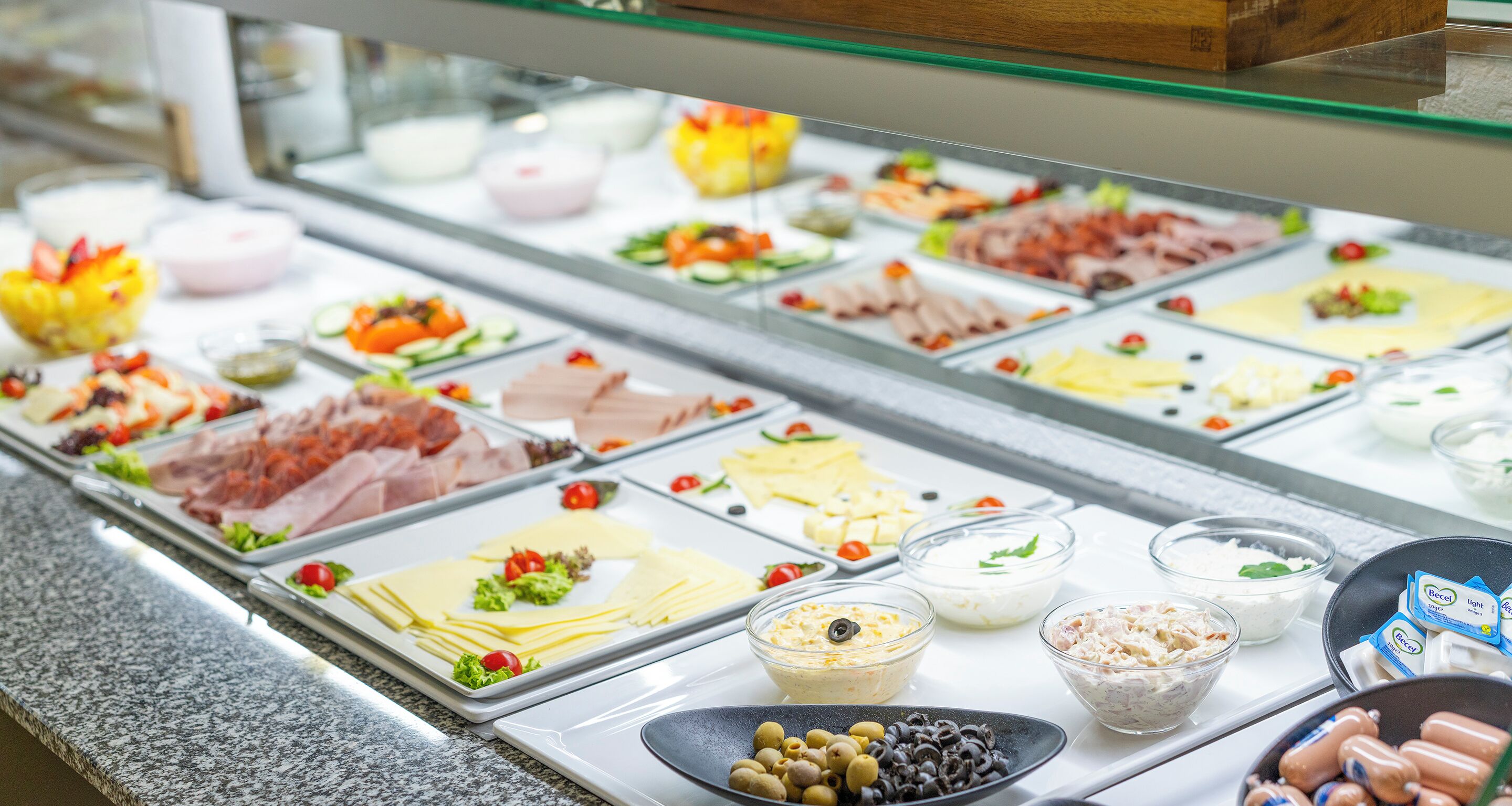 A buffet with various food items and condiments.