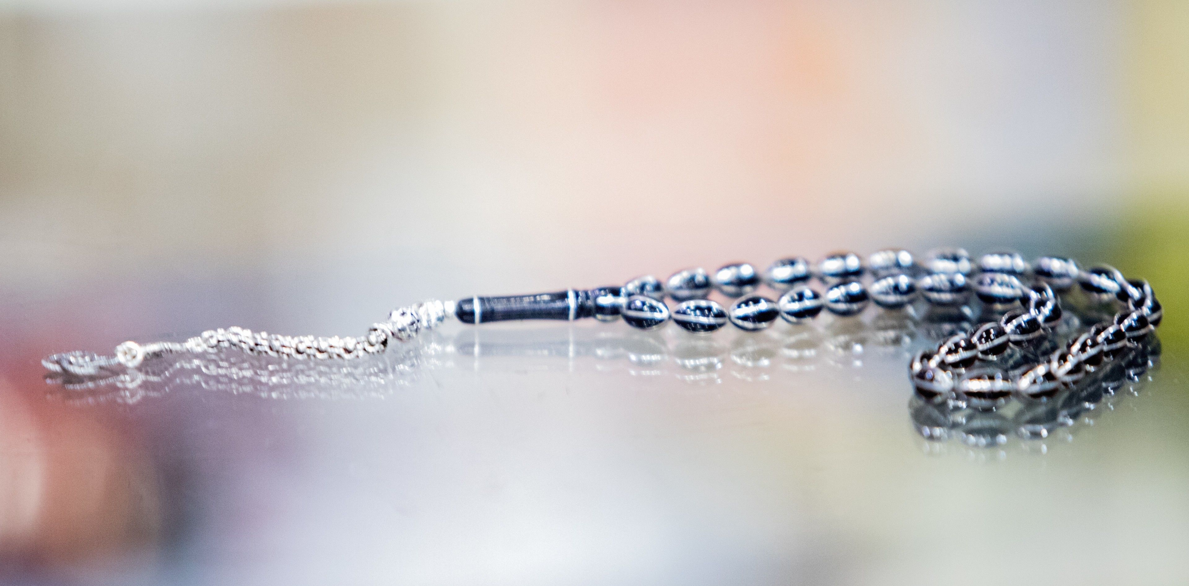 A close-up of a metallic chain with a reflective surface.