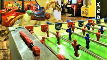Enjoy a game of foosball or challenge friends at the colorful arcade machine in this lively entertainment space.