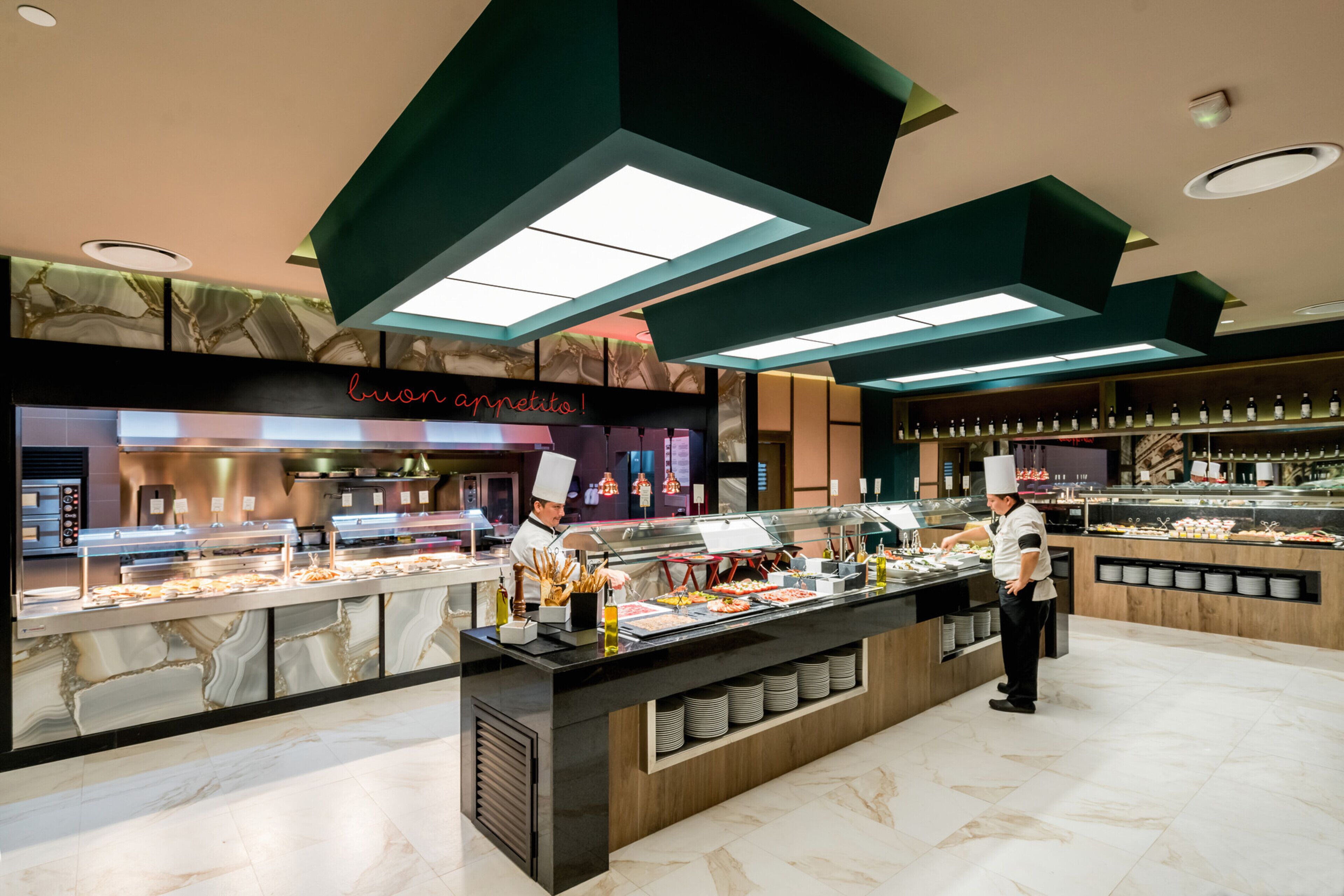 A buffet area with multiple food stations, a chef, and a counter displaying various dishes.