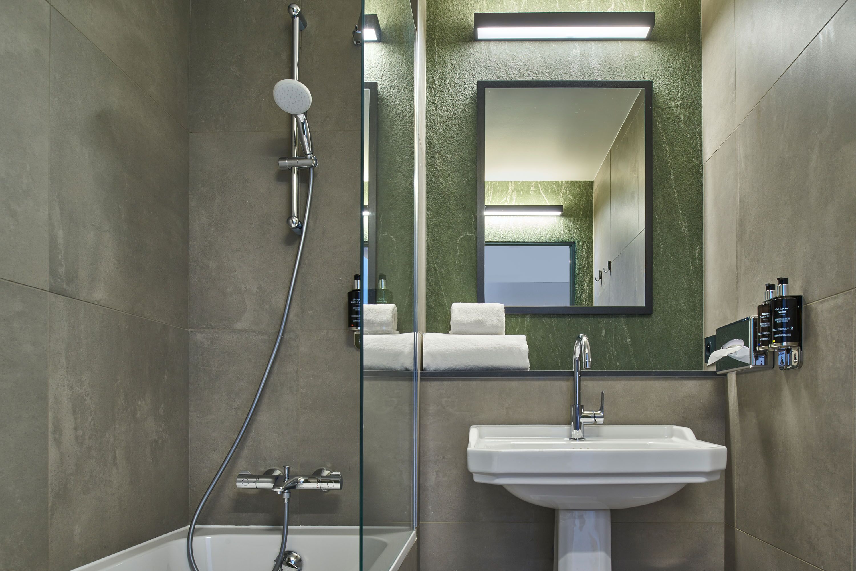 A modern bathroom with a bathtub, a sink, and a shower.