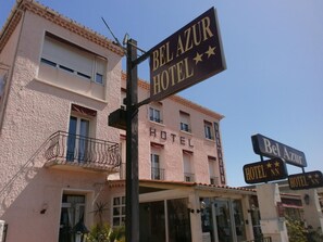 A hotel named Bel Azur Hotel with a signboard displaying its name and stars.