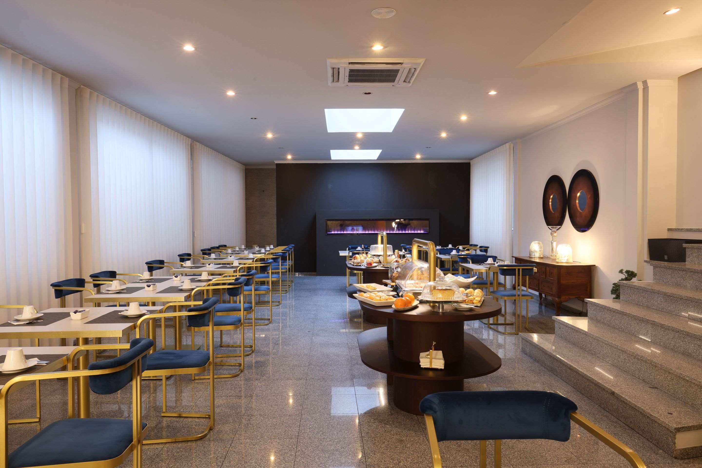 A conference room with tables, chairs, and a buffet setup.