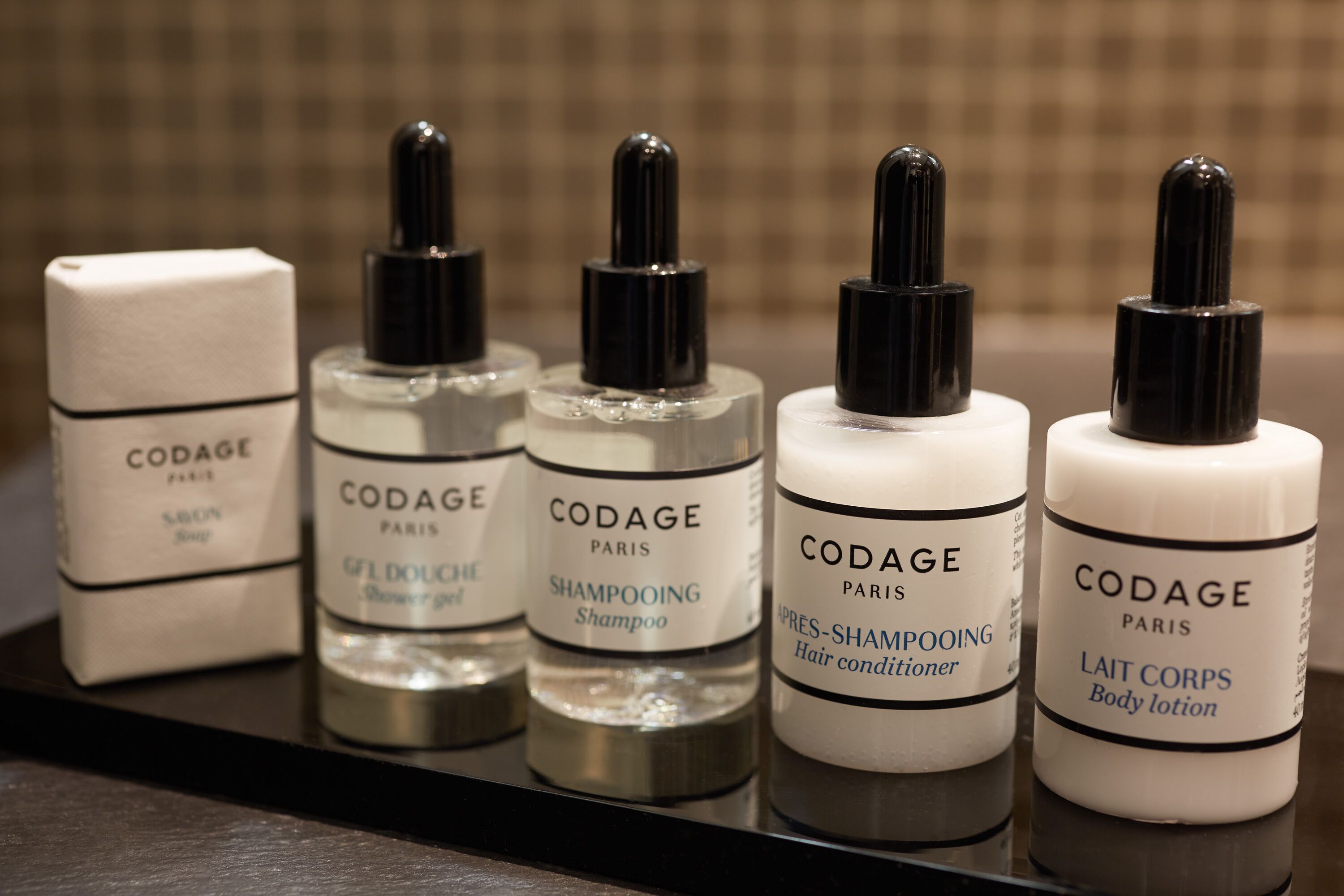 designer toiletries, hair dryer, bathrobes, slippers