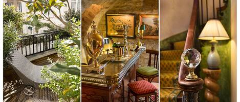A balcony with a wicker chair, a bar area with a gold bar and crystal decanters, and a lamp with a crystal base.