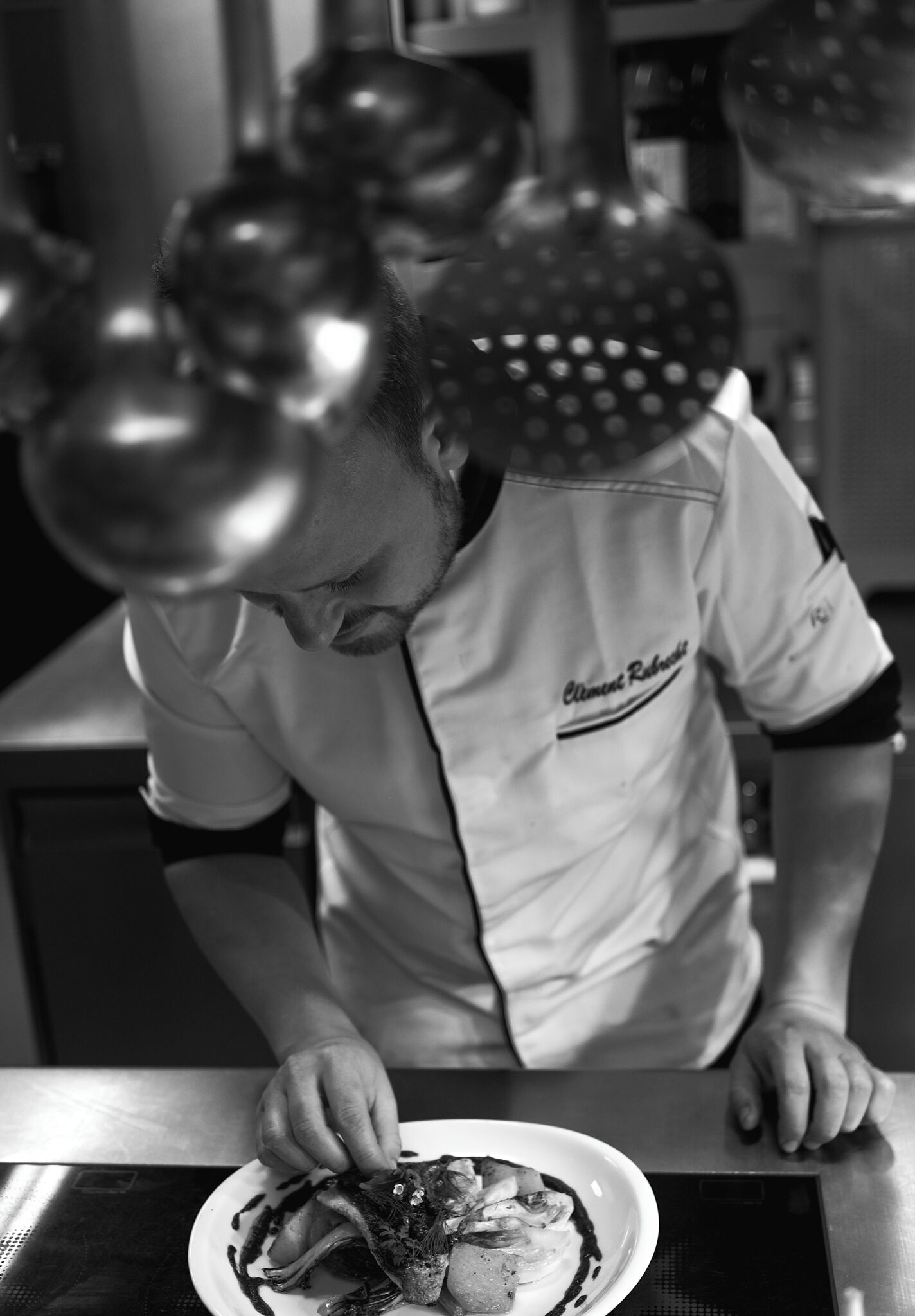 A chef in a kitchen preparing food.