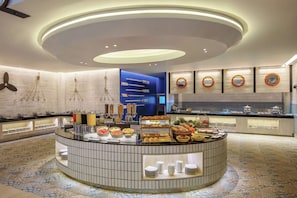 Enjoy a convenient breakfast experience in our modern breakfast area with a central island counter and ample dining space.