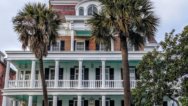 A two-story building with a balcony, columns, and a gate. - 20 South Battery (Charleston)