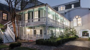 A two-story house with a balcony, a staircase, and a brick pathway. - 20 South Battery (Charleston)