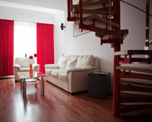 Junior Suite | Living room | 25-inch flat-screen TV with cable channels, TV