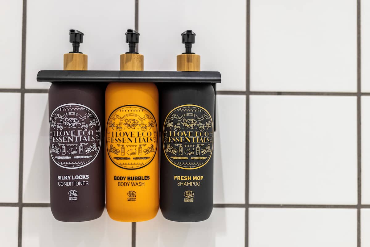 Three bottles of I Love Eco Essentials products on a shelf.