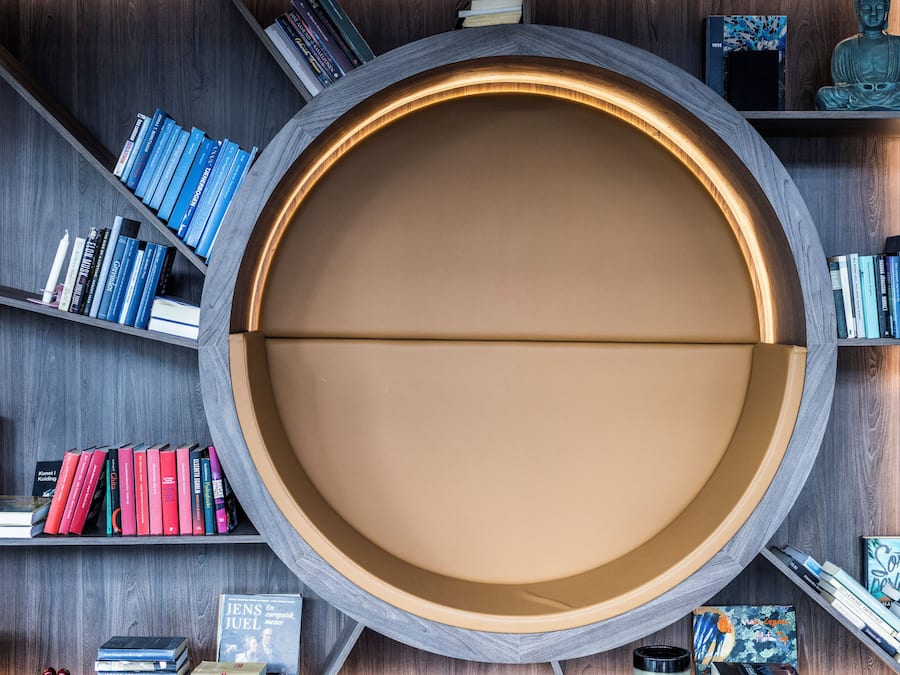 A circular reading area with bookshelves on either side.