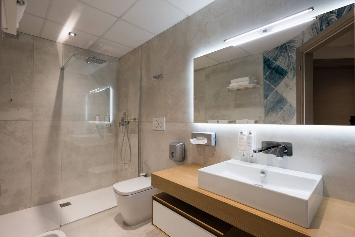 deluxe suite, garden view | bathroom | shower, hair dryer, bathrobes, bidet