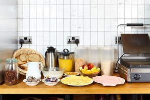 A kitchen counter with various food items and a toaster oven. - St Christopher's Inn Bath - Hostel (Bath)