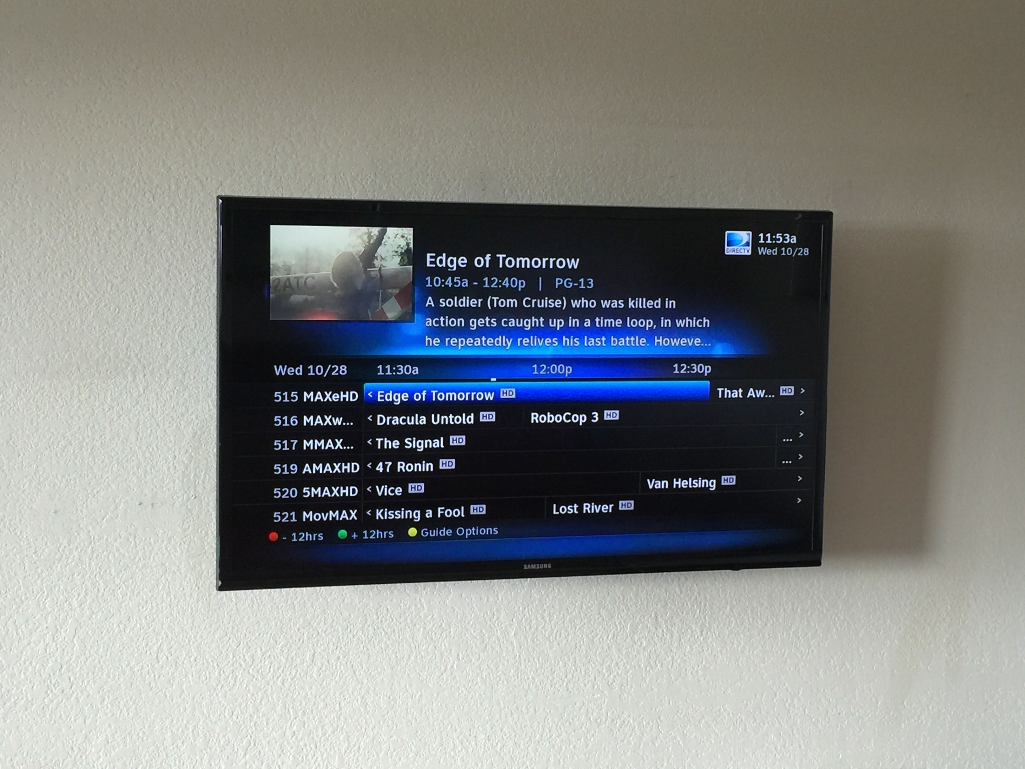 A digital display with a TV channel guide listing various programs and their times.