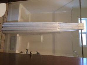 Deluxe Room, 1 King Bed (No Pets) | Bathroom | Combined shower/tub, free toiletries, hair dryer, towels