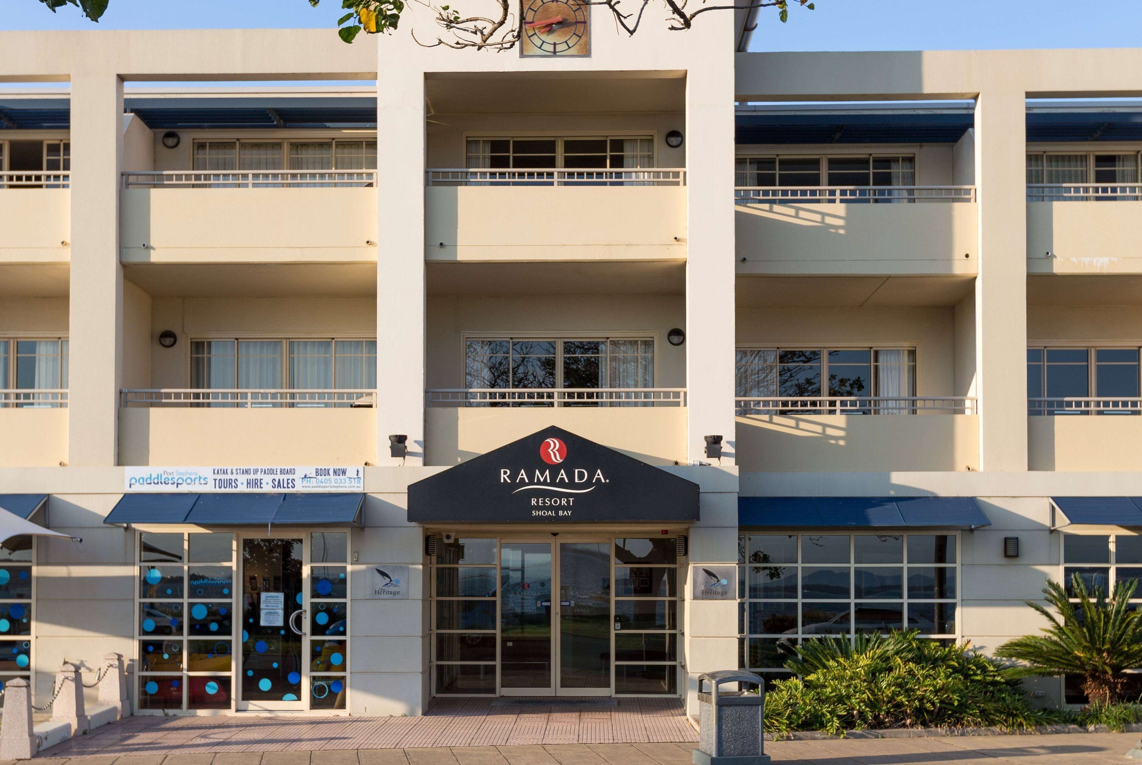 A multi-story building with a sign for Ramada Resort.