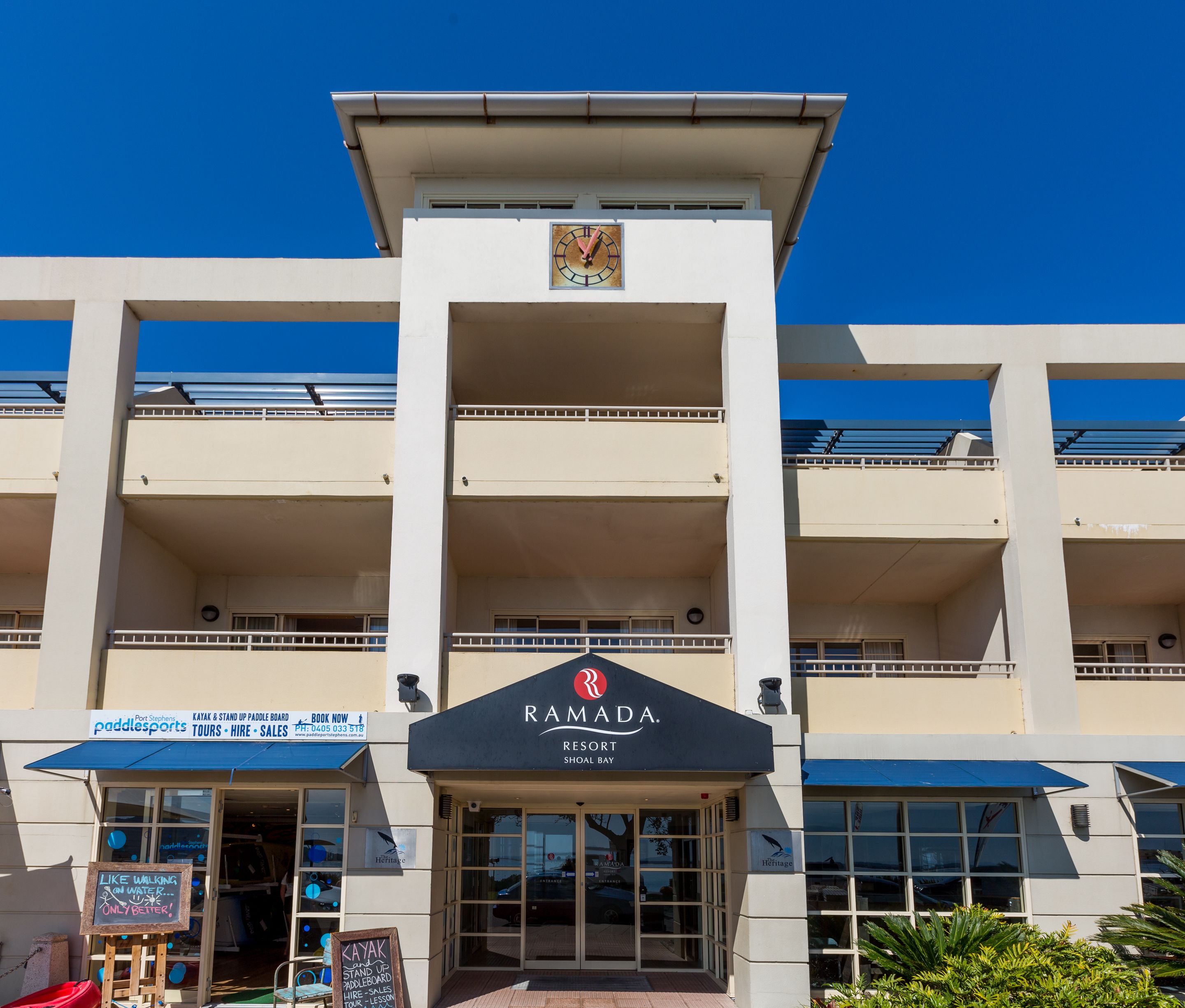 A multi-story building with a sign for Ramada Resort Shoal Bay.