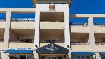A multi-story building with a sign for Ramada Resort Shoal Bay.