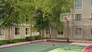 An outdoor basketball court with a net, surrounded by trees and a building. - Homewood Suites by Hilton Allentown-Bethlehem Airport (Bethlehem)